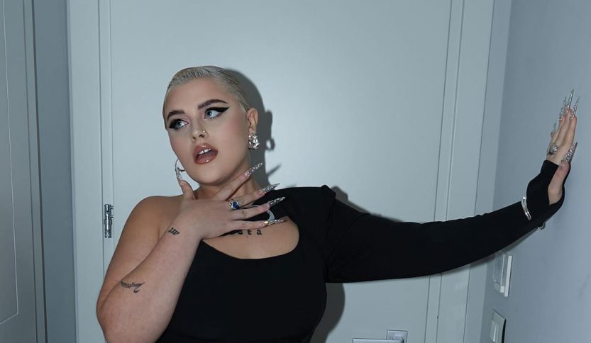 BigMama appoggiata a una parete bianca