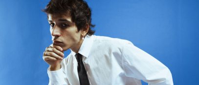 Alex Wyse con cravatta e sfondo azzurro