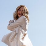 Lorella Cuccarini con completo bianco e cielo